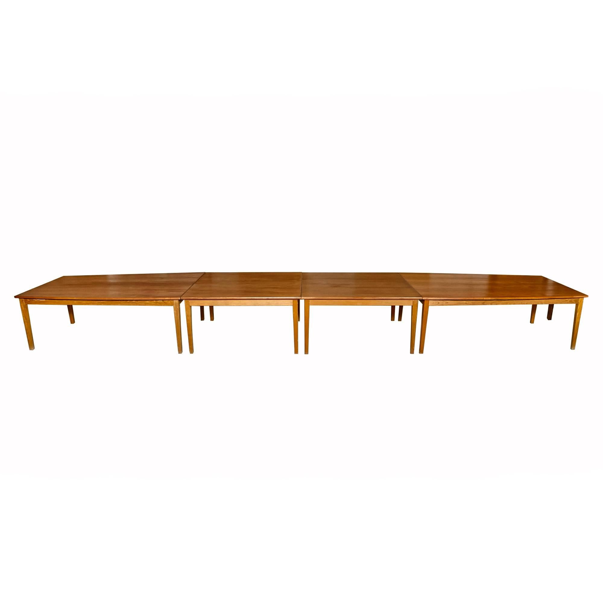 Vintage 1960s teak four section boat-style conference table from Denmark. The two end tables have a slight curve to the edges. The tables can be changed into several different configurations. The tables are not marked. Some light usage wear in