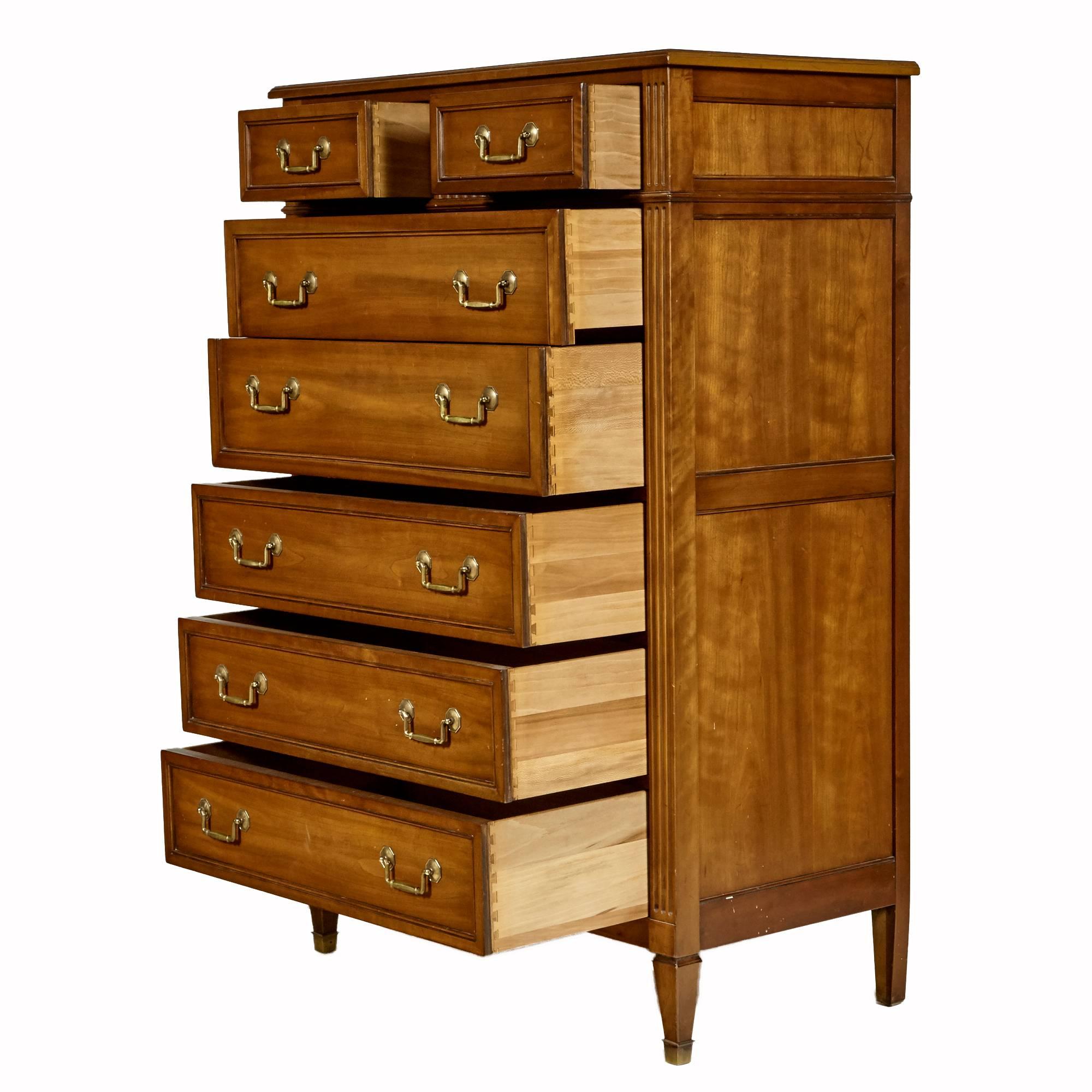 Vintage 1960s tall cherrywood dresser by Kindel Furniture Co of Grand Rapids MI. The dresser has seven drawers and brass accents on the feet with the Belvedere finish. Marked.