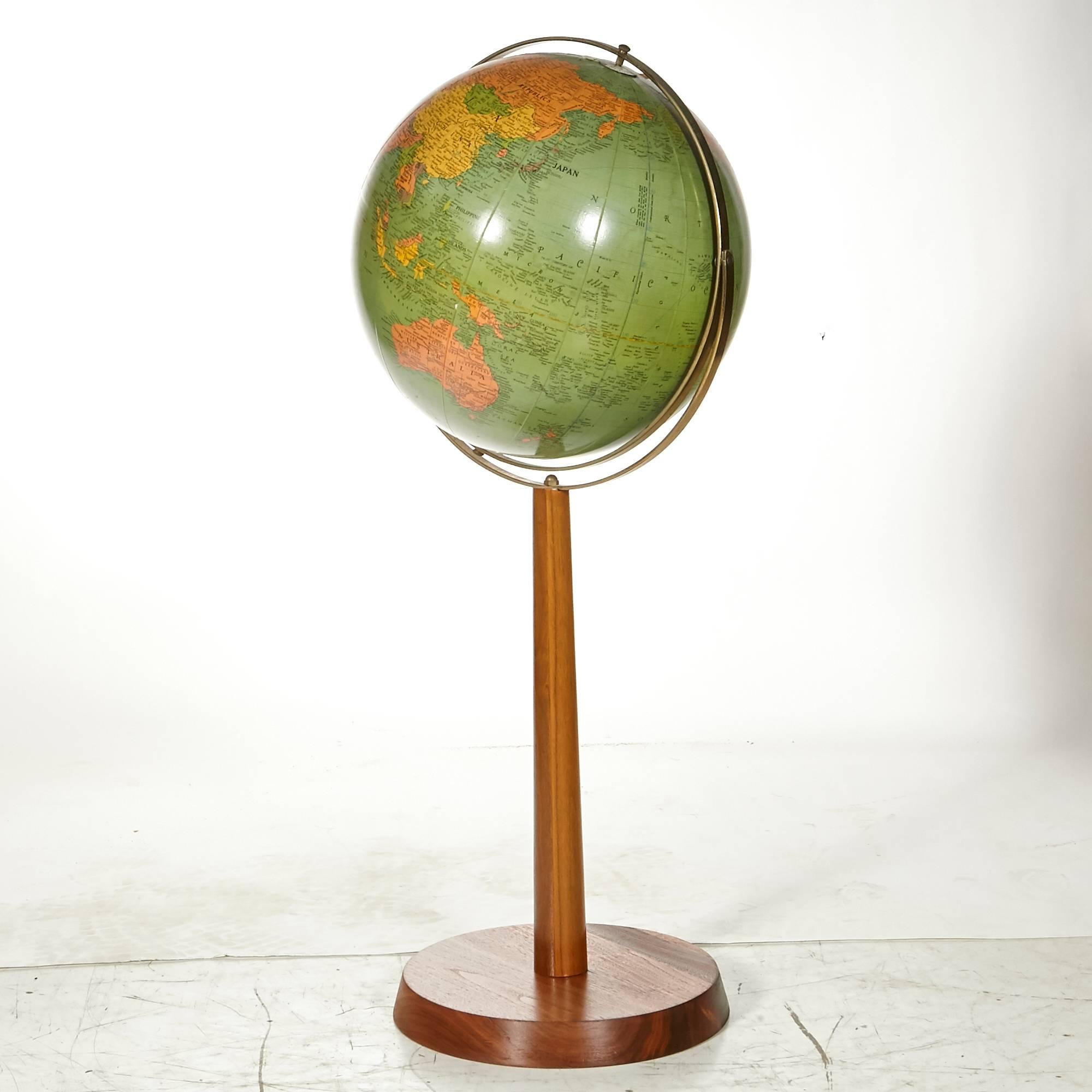 Vintage floor model Replogle 16in. world library globe with a walnut wood base. Base is in refinished condition. Two small spots of loss to paper on top of globe.