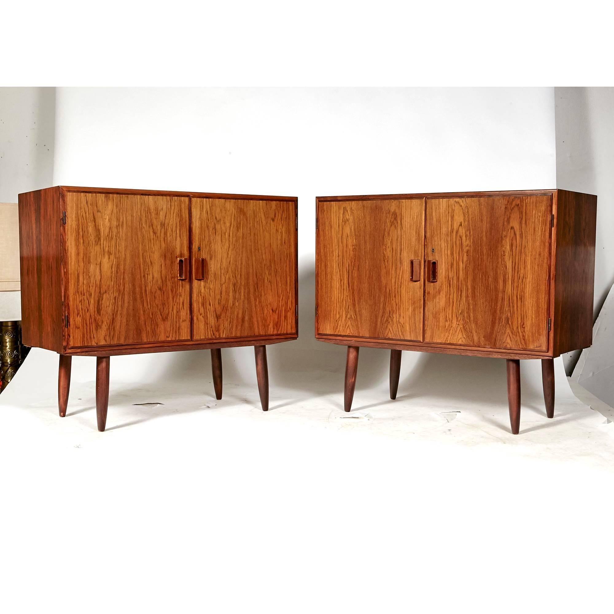 Vintage Scandinavian Modern pair of Danish Borge Mogensen for Povl Dinesen rosewood storage cabinets, circa 1960s. Inside the cabinets are shelving for storage in birchwood. Marked.