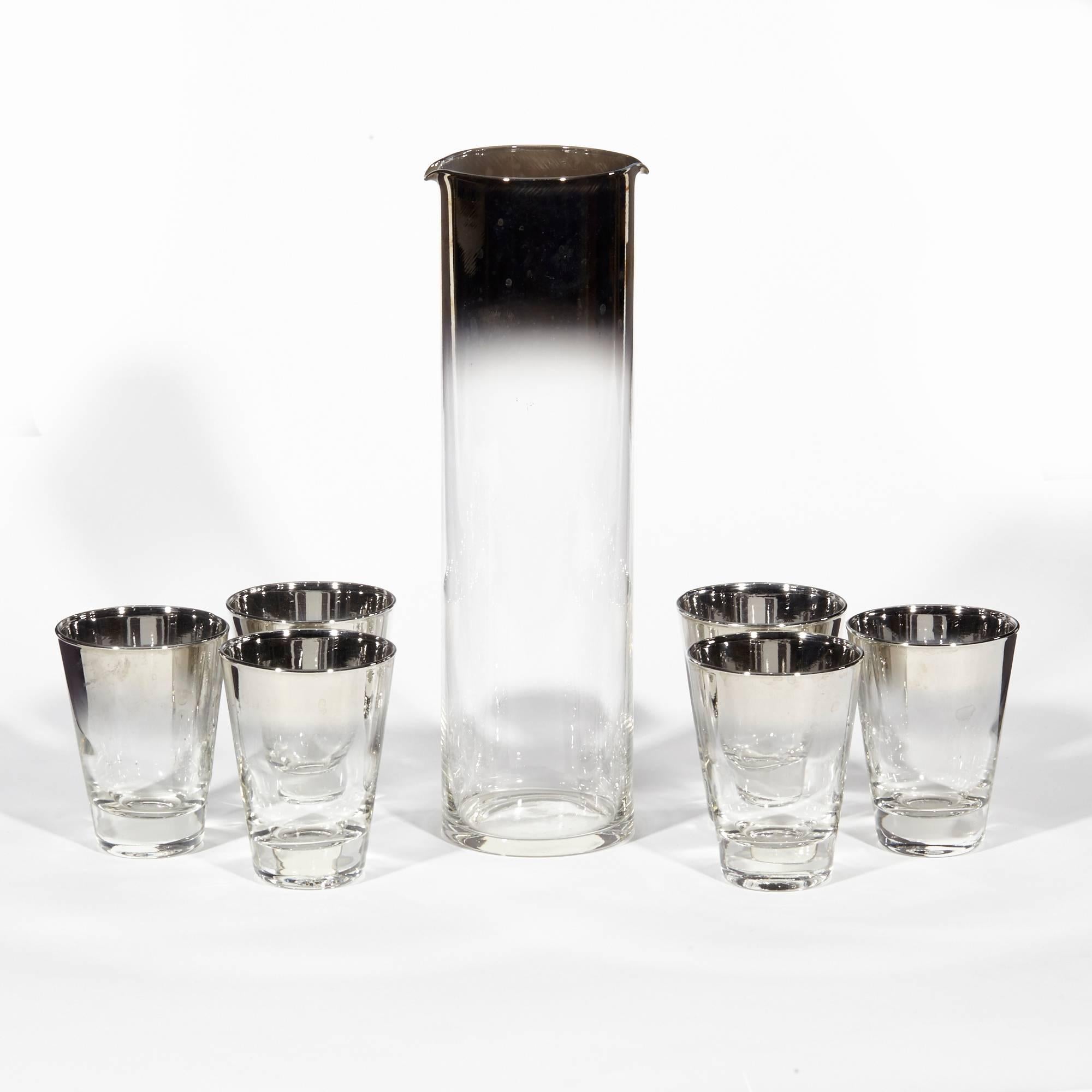 Vintage seven-piece glass cocktail beverage serving set, circa 1960s. The set includes a double spout carafe and 6 liquor tumblers. Tumblers measure 2.5in diameter x 3.5in height.