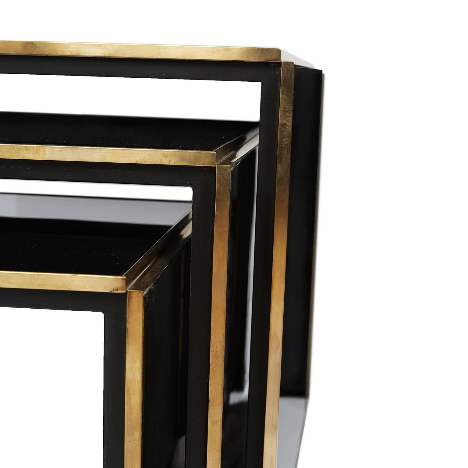 Stunning nest of three tables. Crafted out of acrylic and solid brass. Each table comprised of three acrylic and brass sections. Brass detailing featured on both front and rear. Nest of three is Italian, circa 1970.