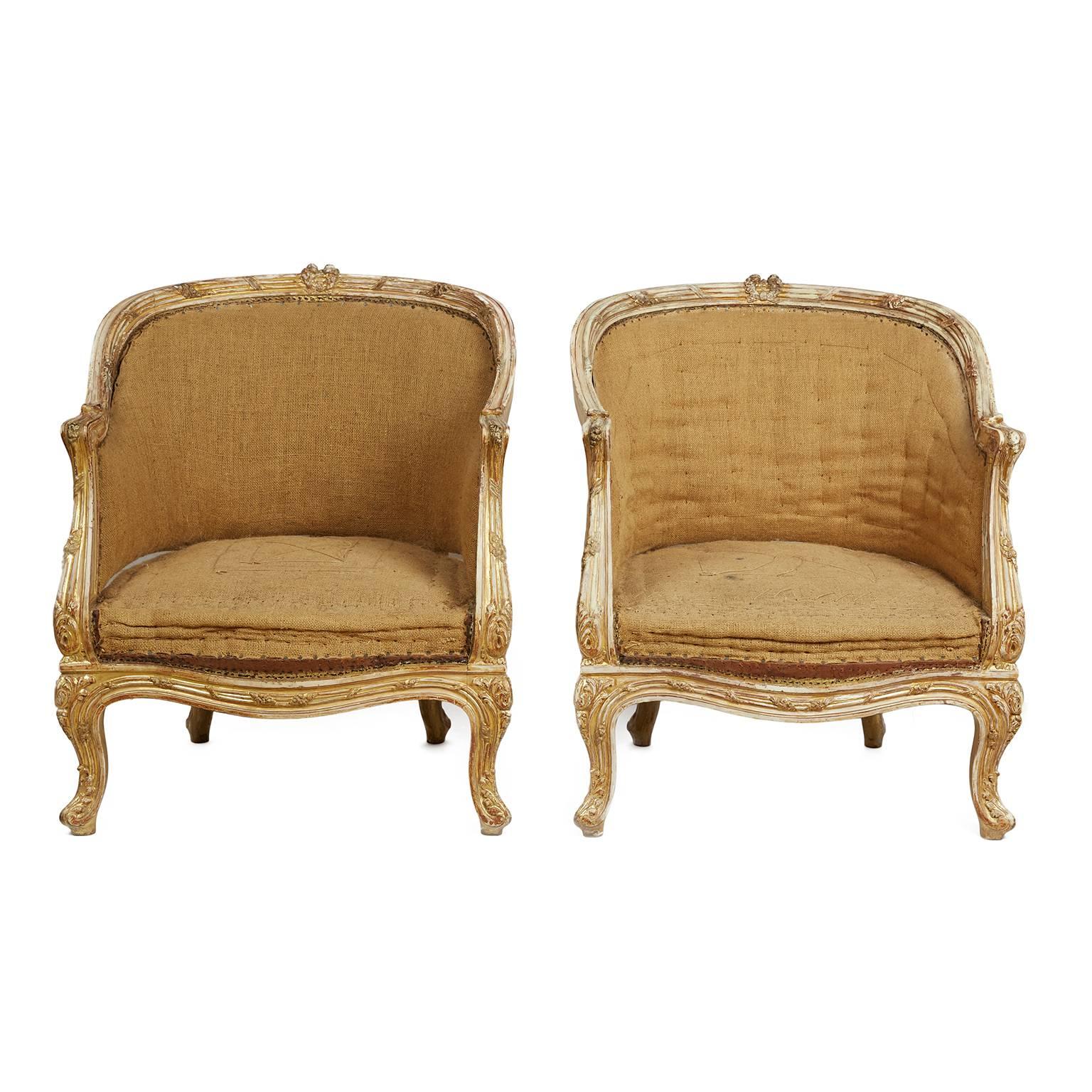 Fine pair of 19th century Bergeres chairs. Stripped down to the original undercover and ready for new upholstery. Wonderful period patina with elegant remnants of paint and golf leaf. Carved details are delicate and sophisticated.