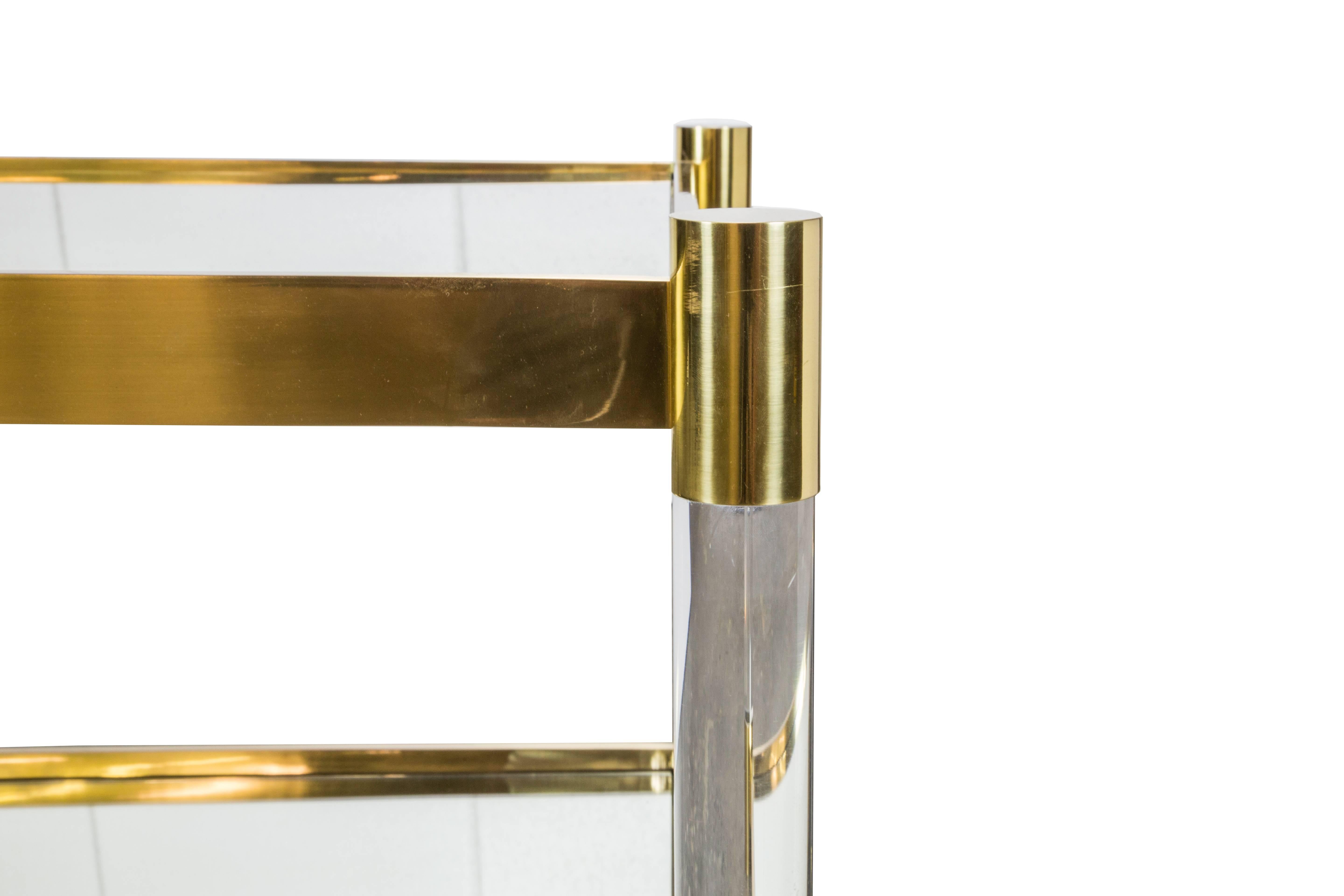 Solid brass and Plexi/Lucite cocktail table. Superb quality with solid brass satin finish. Mirrored glass inserts on top and bottom. This item is custom and one of a kind.