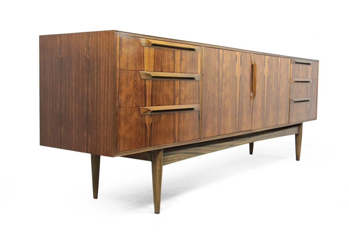 Mid-Century sideboard in rosewood by McIntosh.
A lovely rosewood and mahogany sideboard produced in the late 1950s by McIntosh, three-drawers on either end and a pair of cupboard doors to the center.
This has been fully polished.
Age: