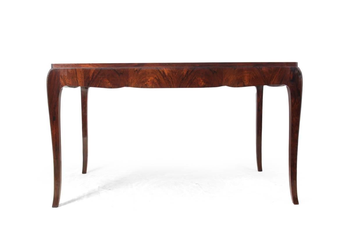 French Art Deco writing table in rosewood, circa 1920.
A very elegant French rosewood writing table produced in solid oak with bookmatched rosewood veneer cabriole style legs with single central drawer at front. In excellent condition throughout,