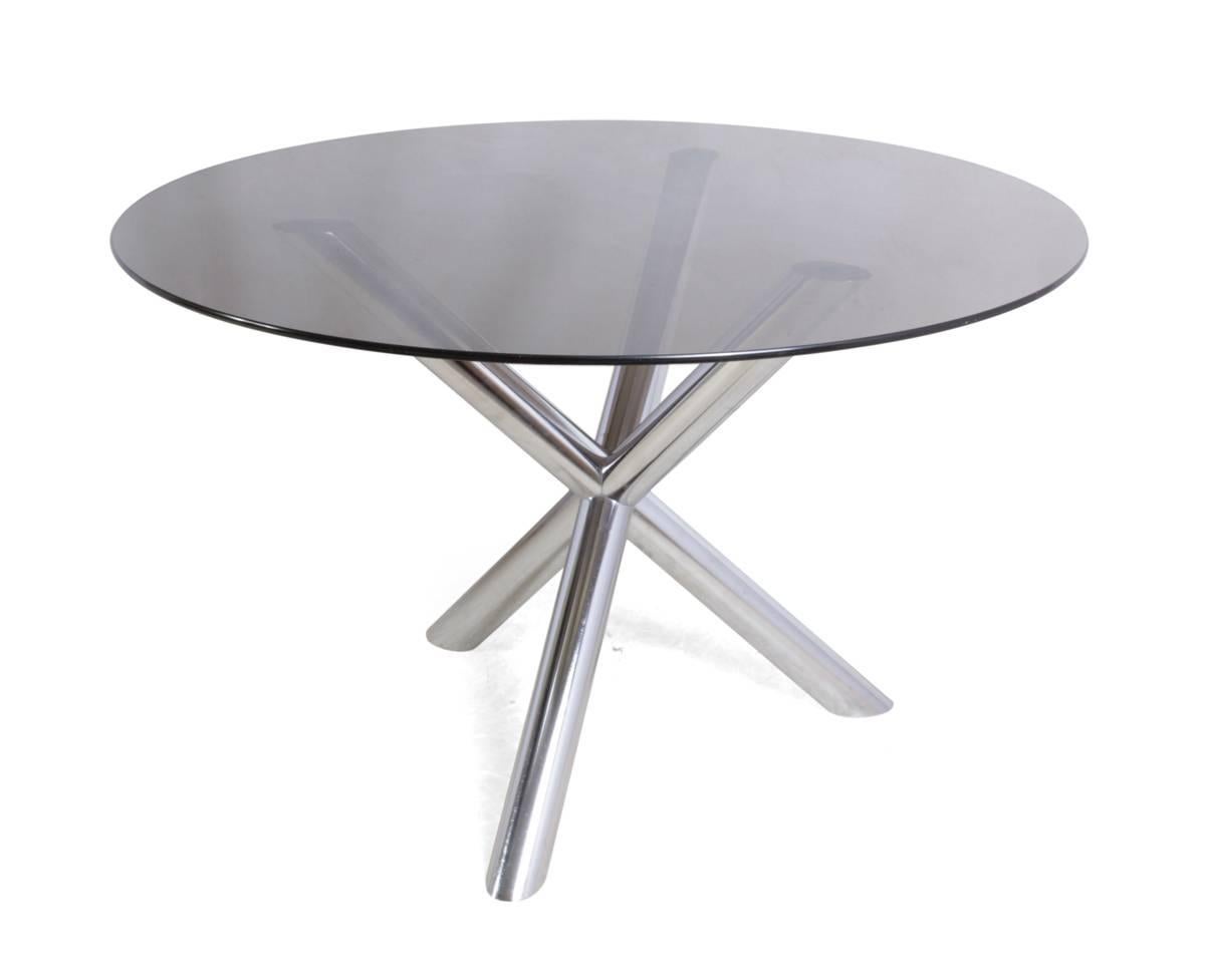 Mid-Century chrome star table.

This Mid-Century circular smoked glass table is in good condition, there are a few scrathces on the class and light marks to chromed base with no flaking chrome or rust coming through.
Age: 1960.
Style: