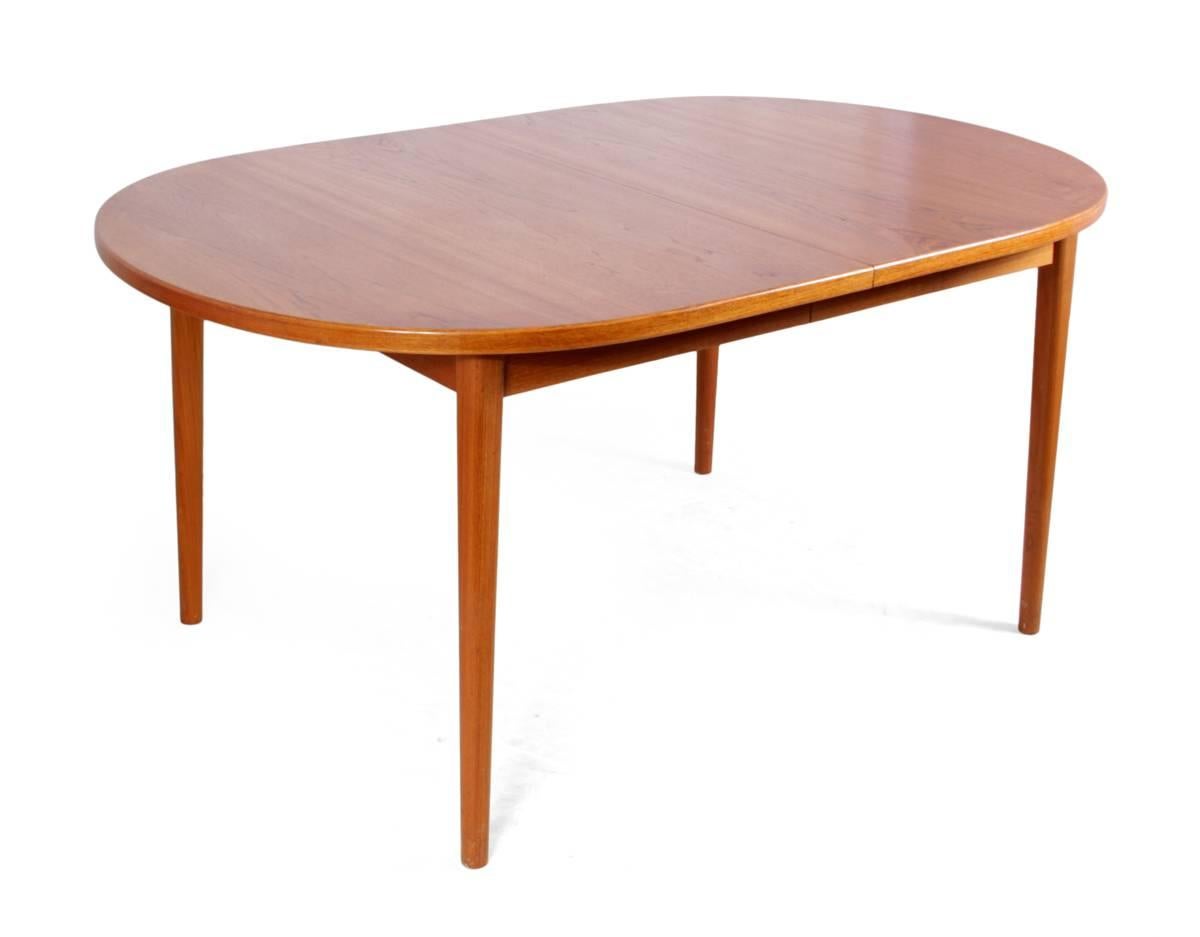 Mid-Century dining suite in teak.

A two leaf dining table with eight chairs. The table is teak and produced by the company Treods. The solid teak dining chairs are stamped with Danish control and have paper cord woven seats. The table has been re