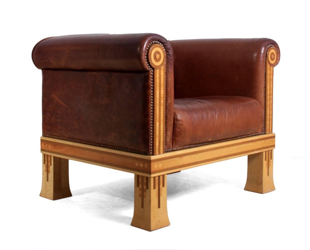 Vintage club chair by David Linley, circa 1980.
This chair was designed and produced by David Linley in the 1980s in the UK it has tan hide leather upholstery and solid sycamore inlaid frame very typical of his work in the early 1980s
The chair is