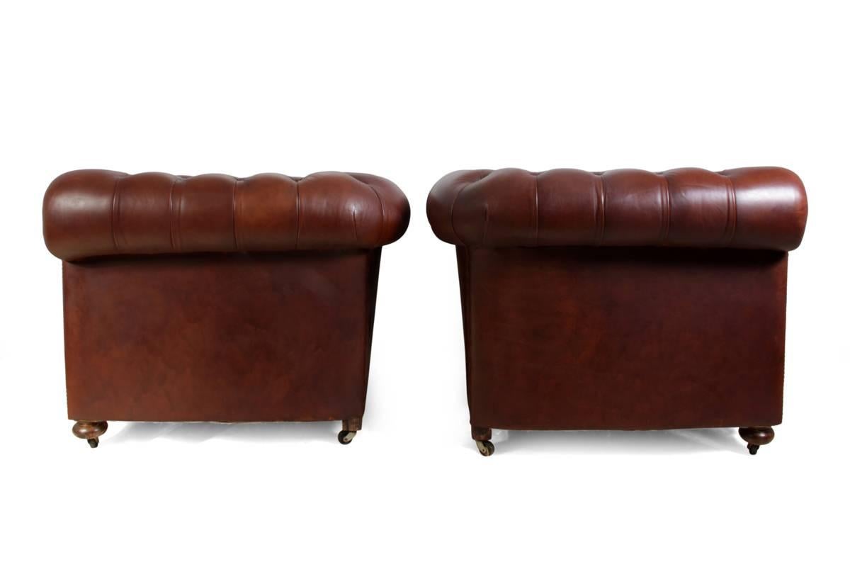 A pair of vintage leather Chesterfield club chairs
A good solid framed pair of buttoned set Chesterfield club chairs with coil sprung seat back and arms. The buttoning on the club chairs are deep with thick hide leather upholstery, studded