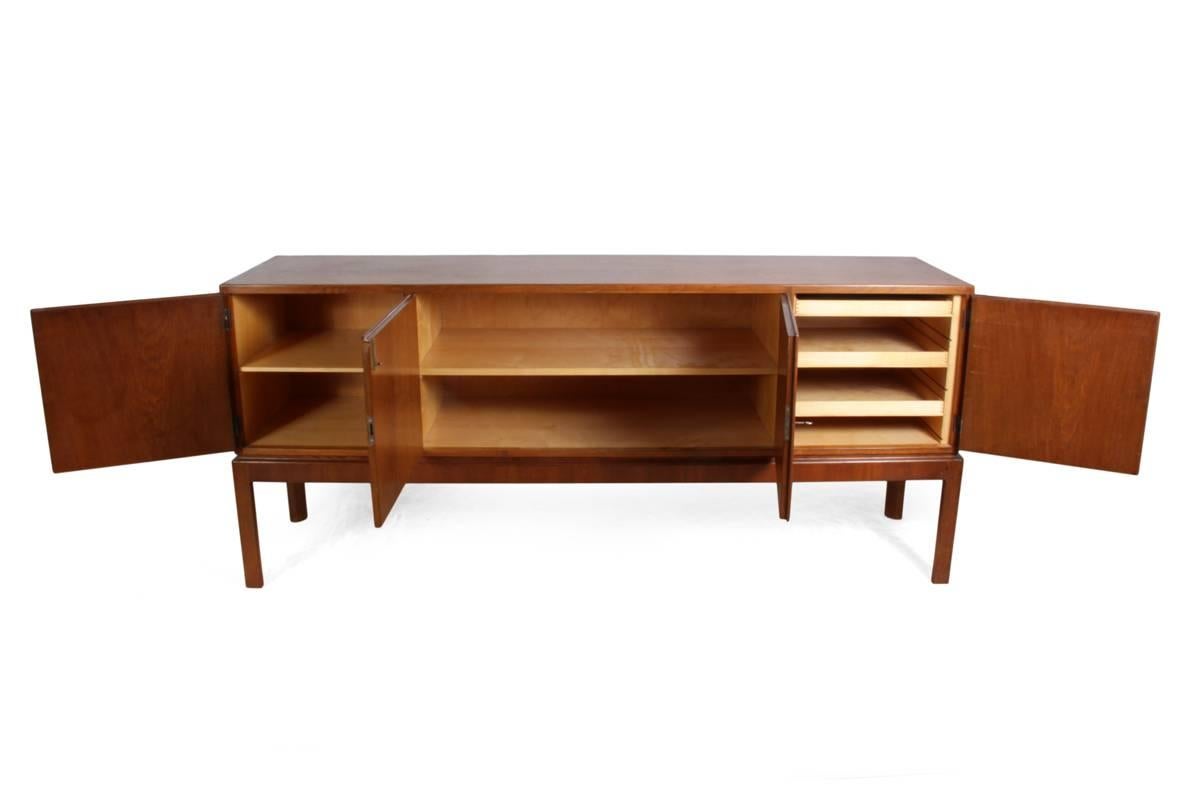 Rare Danish oak sideboard, early 1950s
This sideboard is of solid oak and beautiful dovetail joint construction. It has four doors, the right hand door has finger jointed drawers behind, the other doors have shelves. Early Mid-Century Danish oak