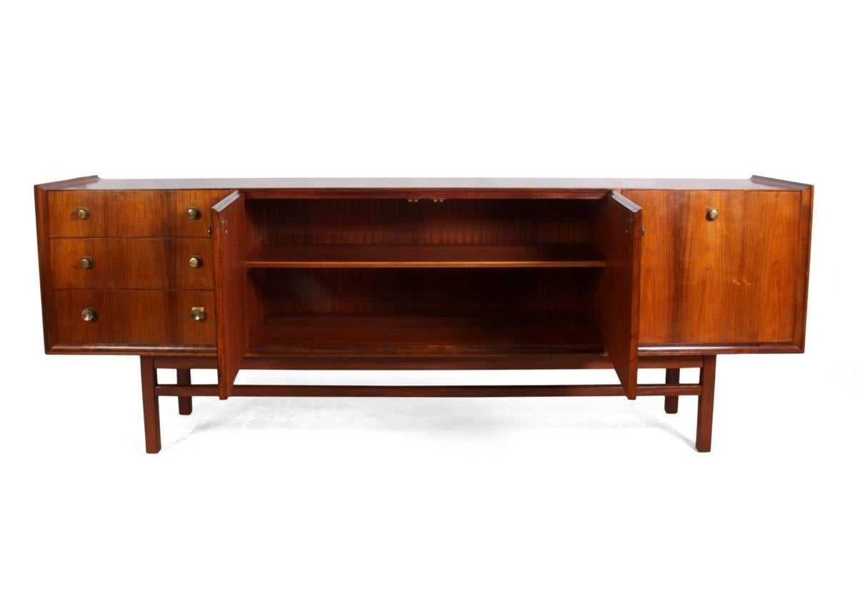 Mid-Century rosewood vesper sideboard by Gimson & Slater
This Mid-Century sideboard has four drawers to the left, two central cupboards and cocktail cupboard to the left, this British made sideboard is in rosewood and mahogany from the 1960s. It is