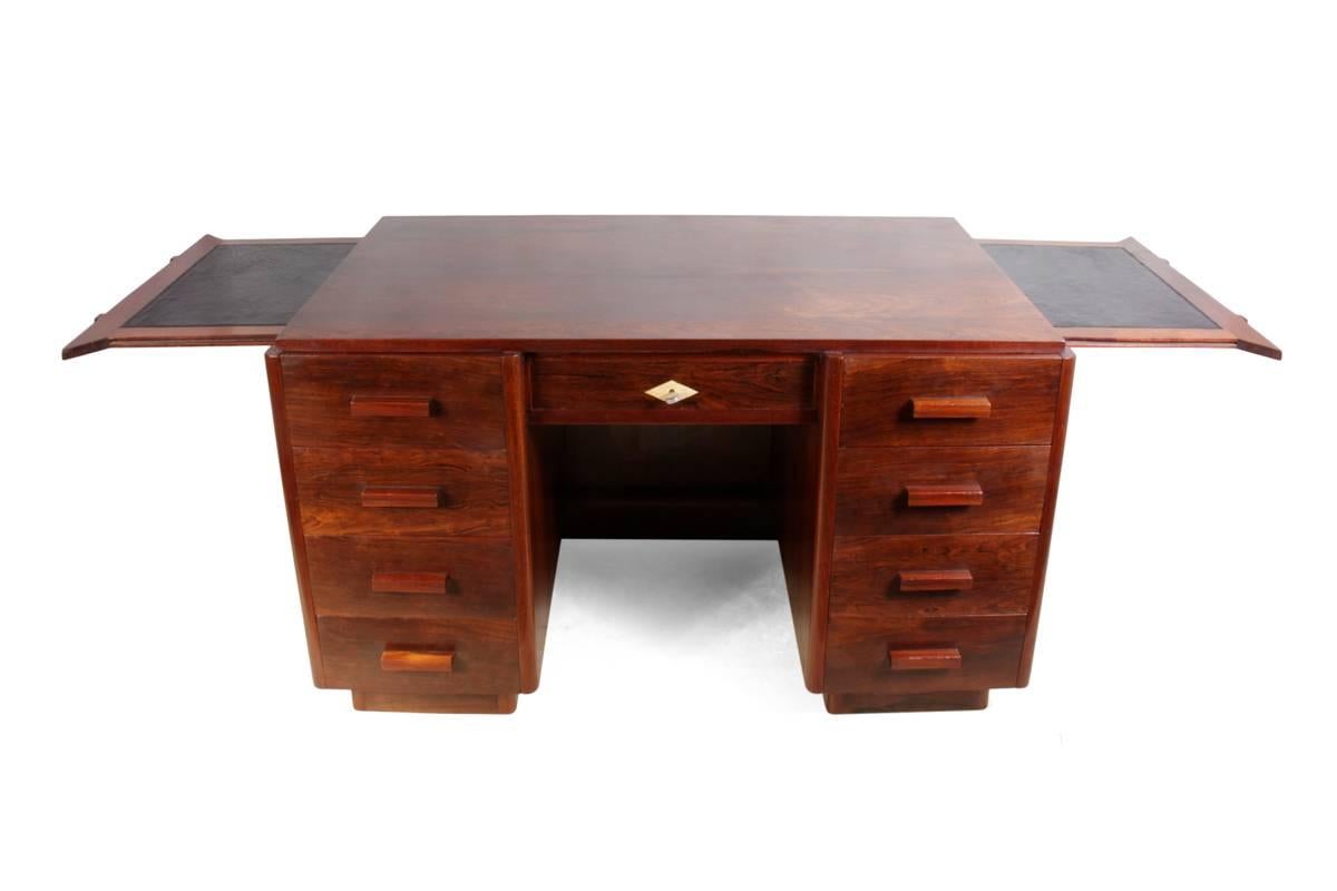 Art Deco desk in rosewood, French, circa 1920
This freestanding, Art Deco, Rosewood desk has nine drawers to the front, it has two leather inset side slides and cupboards to the rear, this has a central locking mechanism that when the central door
