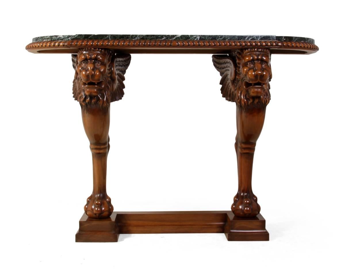 Lion console table in carved walnut and marble
This solid walnut carved console has lion heads with wings and ball and claw feet, pie crust top with green with white vein marble, produced France in the 1920s this console is in excellent condition