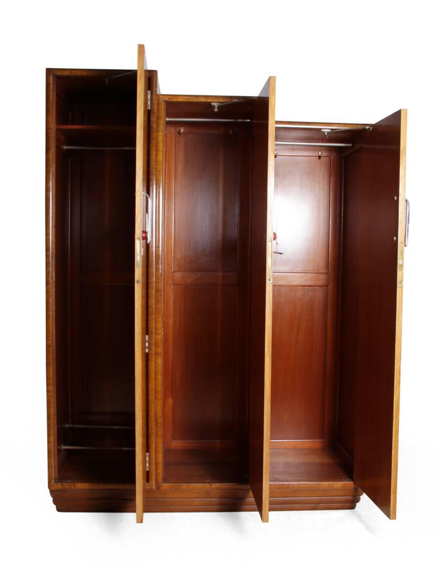 Art Deco wardrobe in Karelian Birch, circa1930

This Art Deco Wardrobe was produced using Karelian birch, bird's-eye maple and walnut it has asymmetrical three cupboard doors that step down with chromed handles and lockable doors the cupboard is