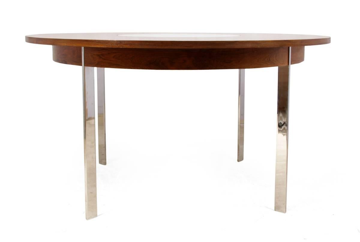 Mid-Century dining table by Merrow Associates, circa 1960
Produced in England in the early 1960s by the well renowned firm Merrow Associates this table has good figured grain rosewood with a white melamine lazy Suzan in the middle and stands on