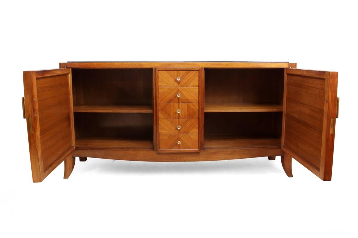 Art Deco rosewood sideboard, French, circa 1930

This sideboard was produced in the 1930s from the solid mahogany and rosewood veneer with brass handles, it has five central drawers with hand cut dovetail construction, adjustable shelves behind