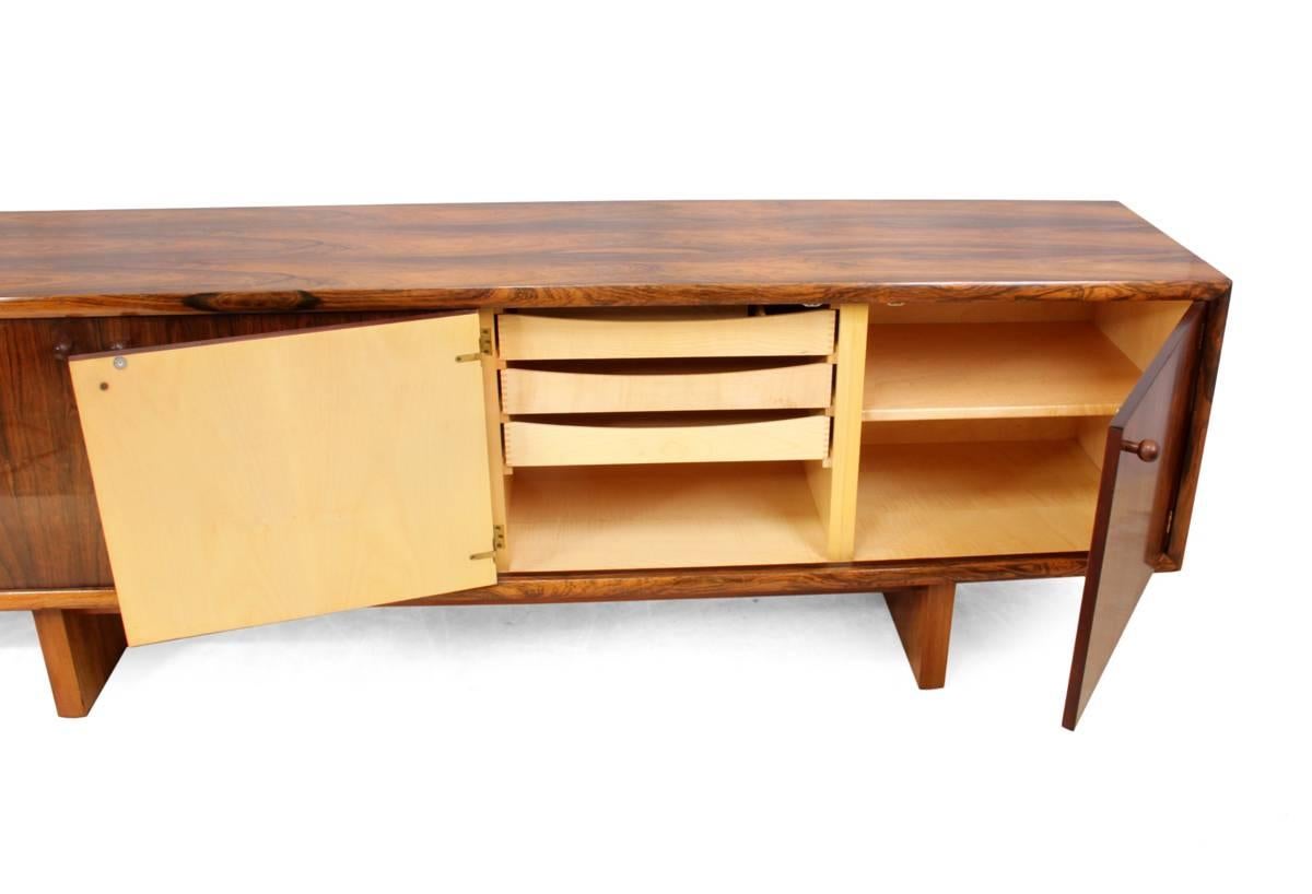 Rosewood sideboard by Gordon Russell GR75
Designed by Martin Hall this sideboard was produced by Gordon Russell in the early 1970's, this four door sideboard is maple lined and is in excellent original condition
Age: 1975
Style: Mid-Century