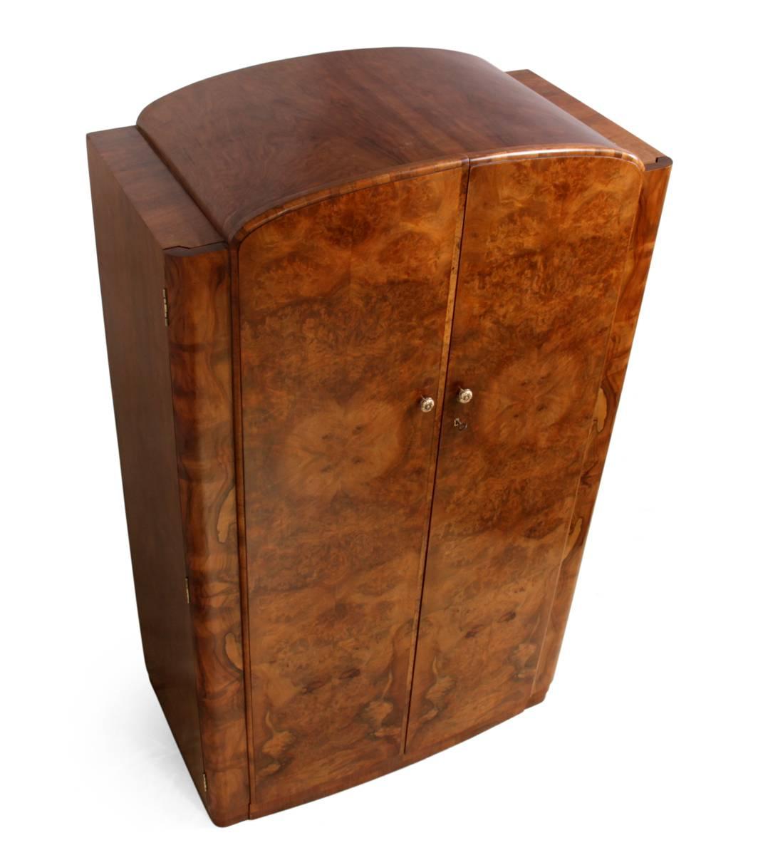 Art Deco burr walnut wardrobe, circa 1930.
A bow fronted two door gentleman's wardrobe with shelves fitted and pull out hanging rail fitted inside, the top is domed the wardrobe has been professionally restored and hand polished.
Age: 1930
Style:
