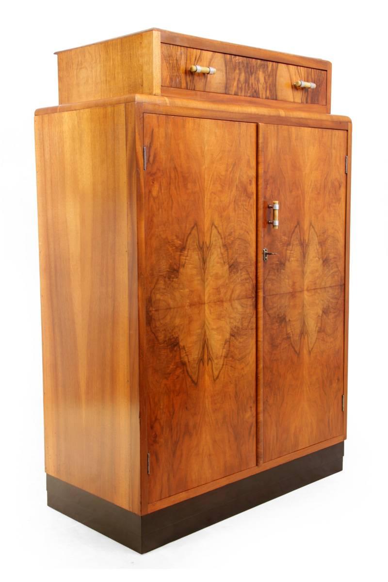 Art Deco walnut gentleman's wardrobe
This walnut compact wardrobe was originally produced for gentlemen, with a shirt hanging rail shelves to the right a tie rail and a little compartment for camphor, the cupboard is lockable and has original key,