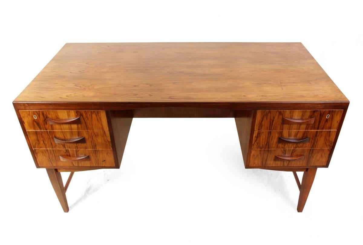 Midcentury Danish rosewood desk
This Danish produced free standing six drawer desk has solid rosewood sculpted handles and drop down cupboard to the back, the key supplied works all three locks, the desk has been professionally hand polished and is