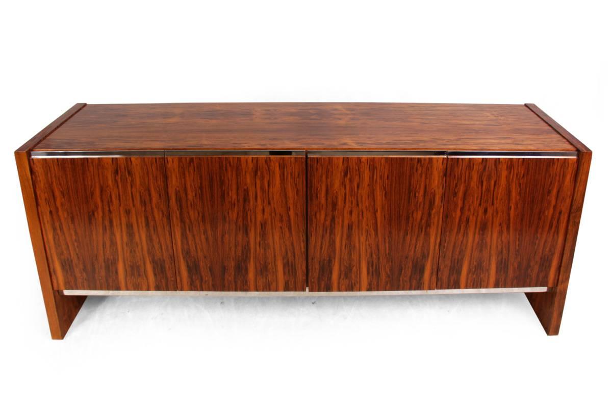 Cocobolo sideboard by Merrow Associates
This four-door sideboard produced in the early 1970s using the very rare and exotic Cocobolo veneer, this sideboard opens to reveal a bank of drawers to the left and a glass shelf to the rest, it is in