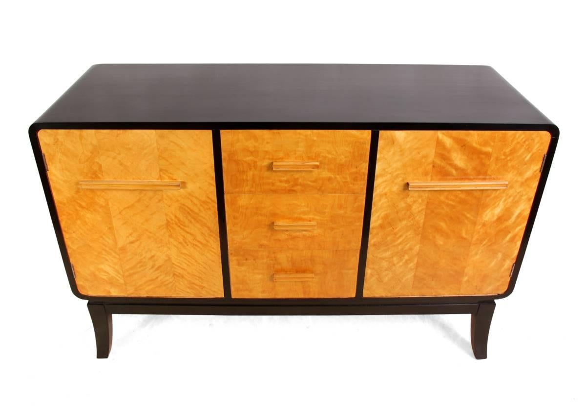 Scandinavian Art Deco sideboard, circa 1940
This Scandinavian sideboard has been ebonised with satin birch drawer and door fronts it has four central drawers and two cupboards with shelves behind, the sideboard is in very good condition and has