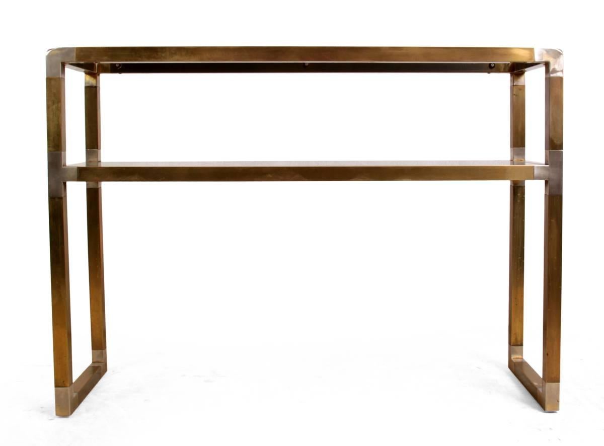 Italian brass and steel console table, circa 1960
A Mid-Century Modern design brass and steel console table with smoked glass shelves, the brass has been cleaned but leaving the years of patina, the lower glass shelf has some small chips on one