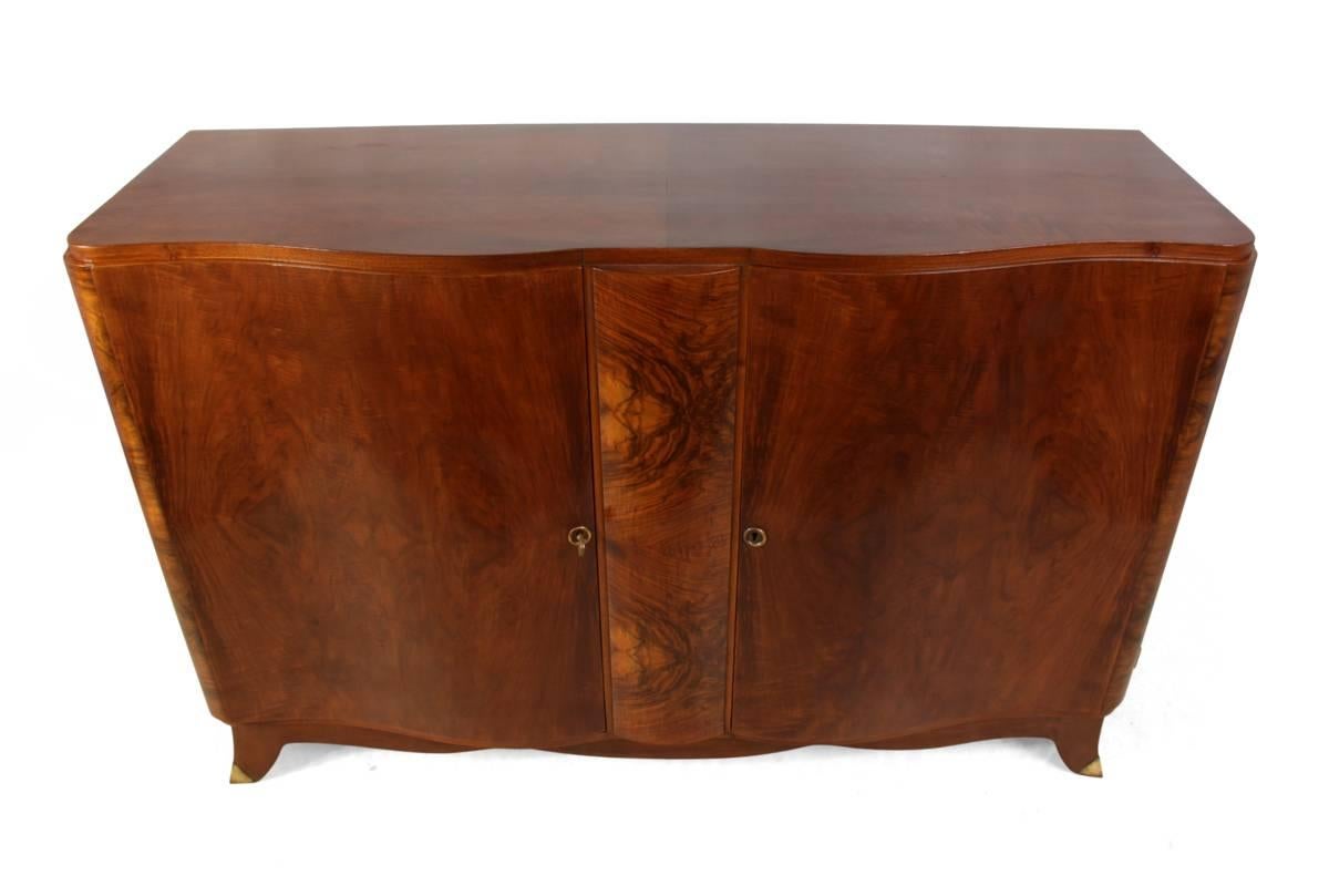 Art Deco walnut sideboard
A two door French walnut sideboard has a serpentine front and brass tipped feet, the sideboard has been professionally restored and hand polished
Age: 1930
Style: Art Deco
Material: Walnut
Condition: Very