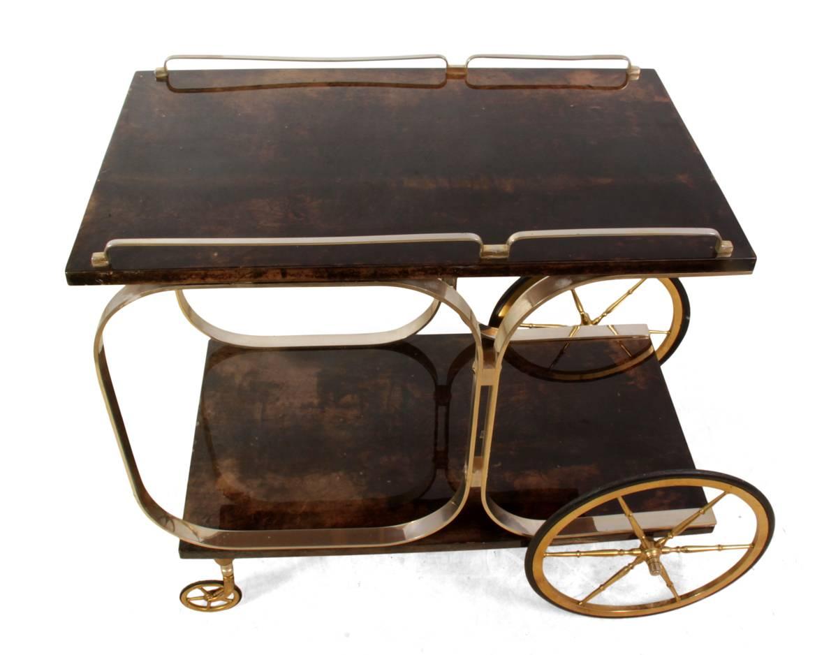 Italian brass and goatskin trolley by Aldo Tura, circa 1970
This lacquered goatskin and brass drinks trolley was designed and produced in Italy in the 1960s by Aldo Tura, it is in original condition with wear the rubber on the wheels has pitting