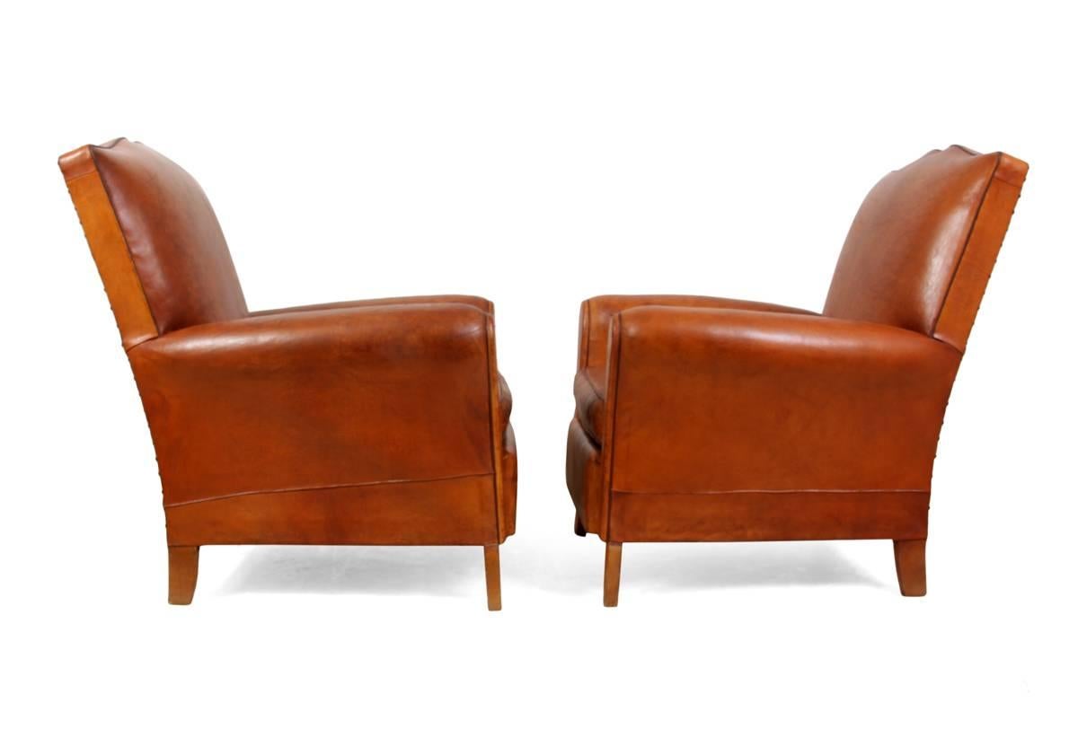 Pair of moustache back French leather club chairs
A good quality pair of leather club chairs produced in France in the 1950.'''''''' Sprung seat back and arms, these chairs have the desirable moustache back and are in good quality thick leather