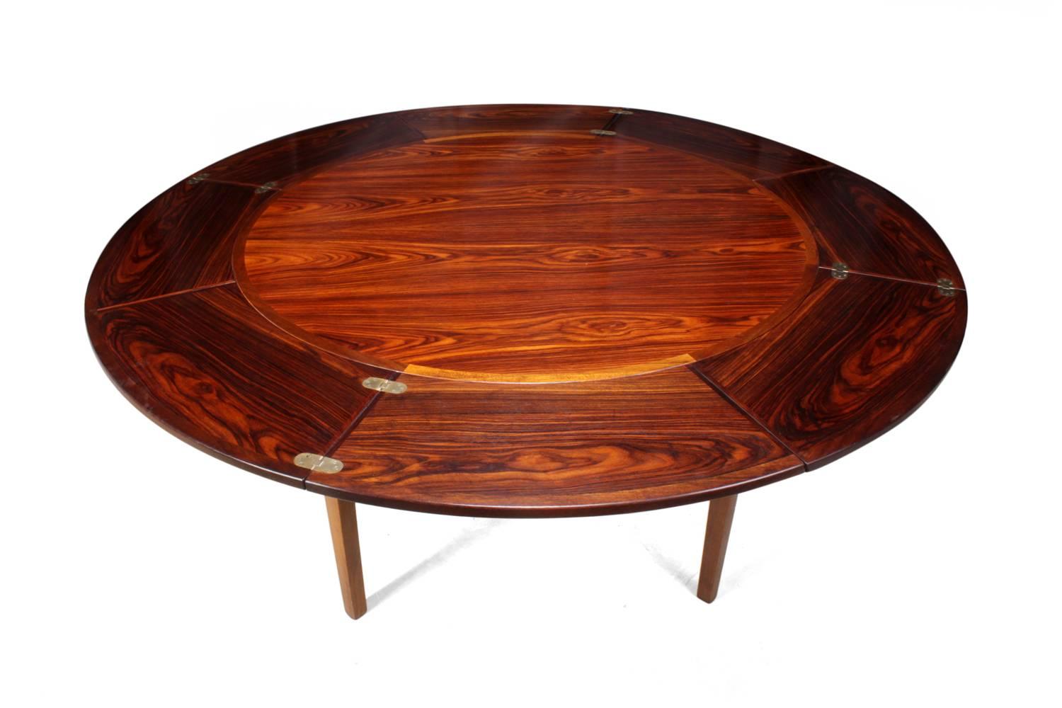Rosewood flip flap lotus table by Dyrlund
A Danish rosewood dining table by Dyrlund with flip flap extension leaves that neatly slide underneath this table will seat four in closed position but with leaves out this will seat eight the table is in