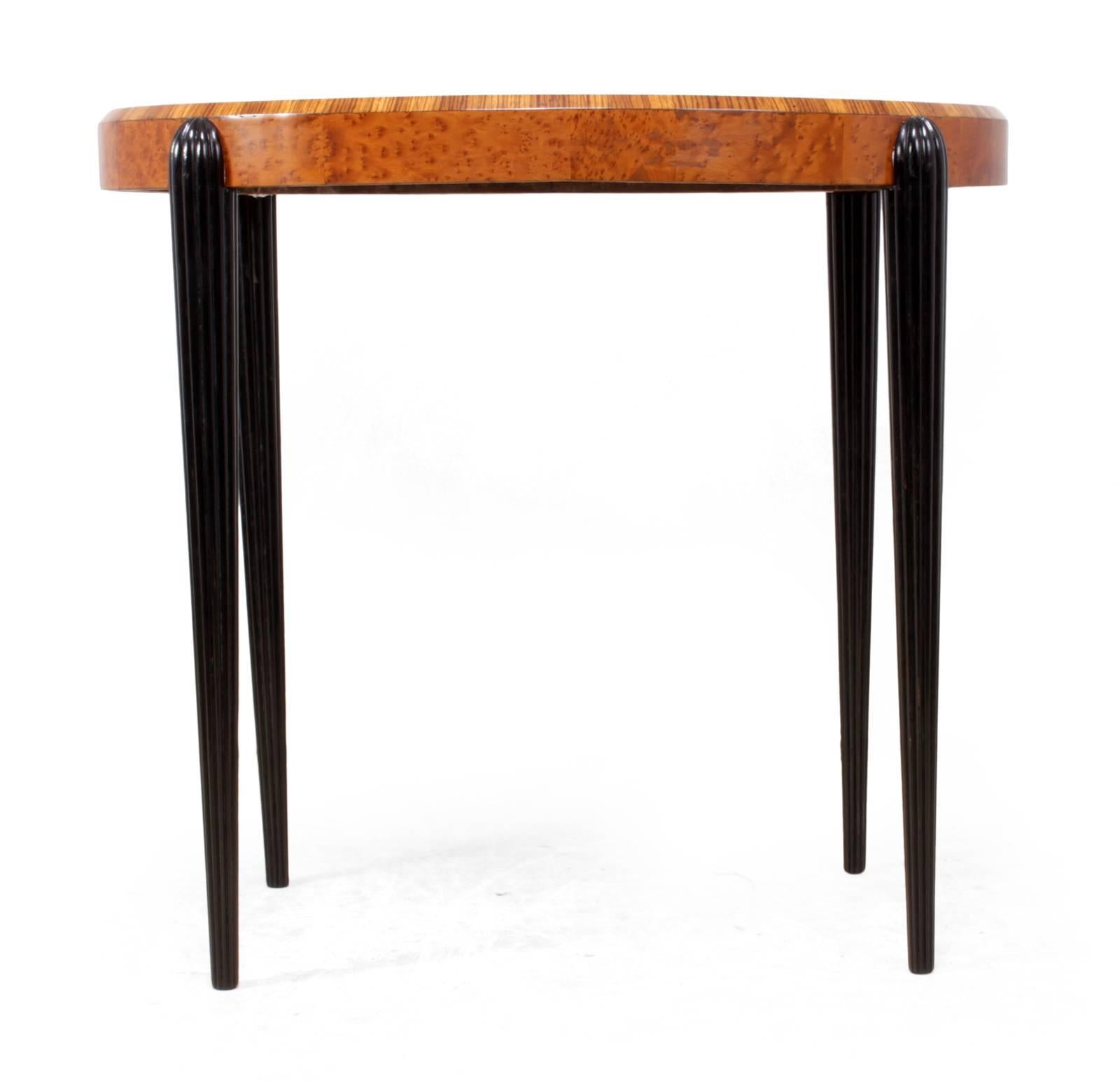 Art Deco side table in the style of Rhulman
A very good Art Deco side table produced in the style of Rhulman with fluted legs and bird’s-eye maple and zebrano oval shaped top this table has been fully restored and hand polished

Age: