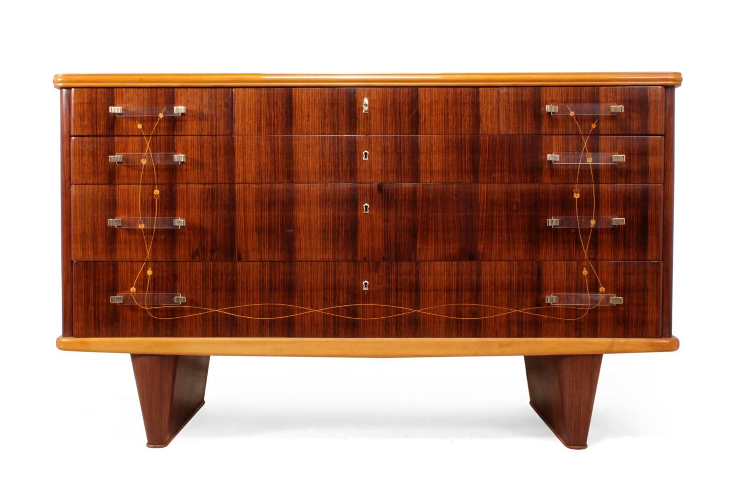 Italian rosewood commode by Dassi
Produced in Italy in the 1950s by Vittorio Dassi with his typical line-work with flowers inlay the chest has a black glass top, three long drawers and three short drawers above, four drawers are lockable with one