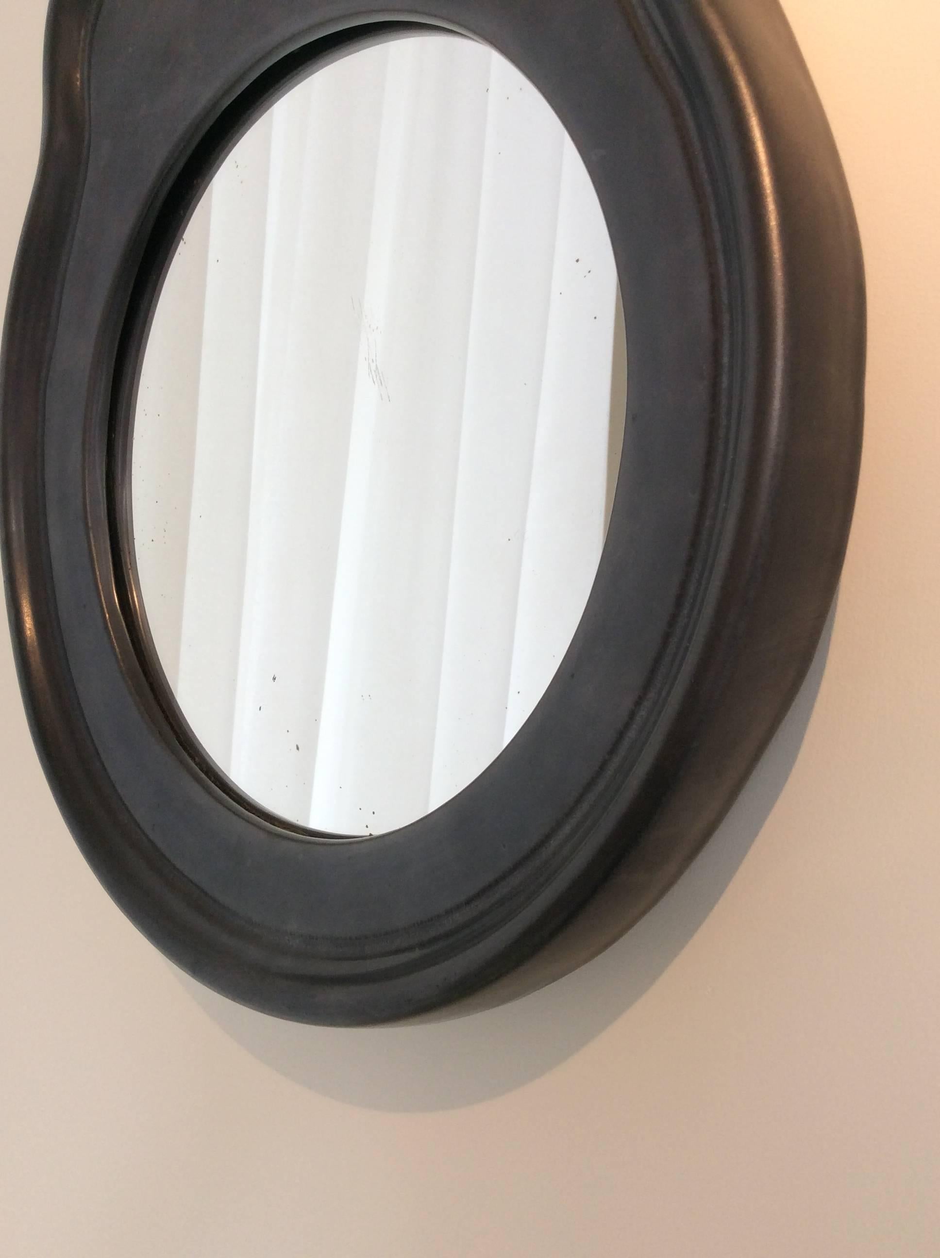 Black ceramic mirror, circa 1950. France. 
Good original condition. 
Measures: H 41 cm, W 34 cm, D 3,5 cm.