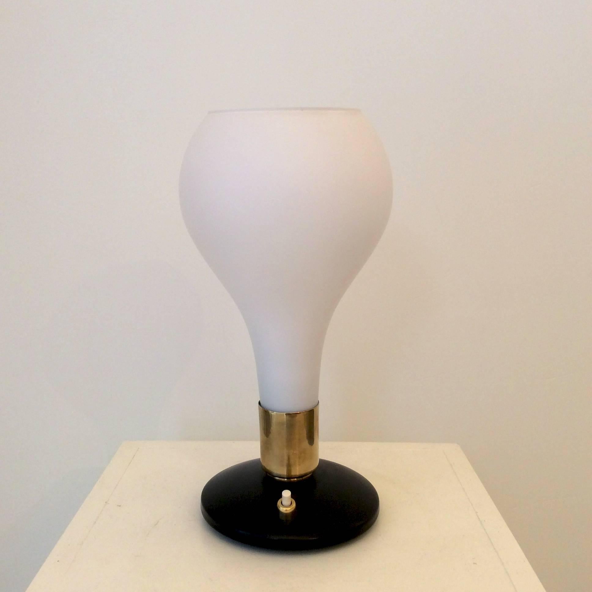Table lamp attributed to Stilnovo, circa 1960, Italy.
Black lacquered metal base, brass and white opaline.
One E14 bulb of 40 w.
Dimensions: H 28 cm, D 14 cm.
Good original condition.
We ship anywhere in the world, please feel free to request a