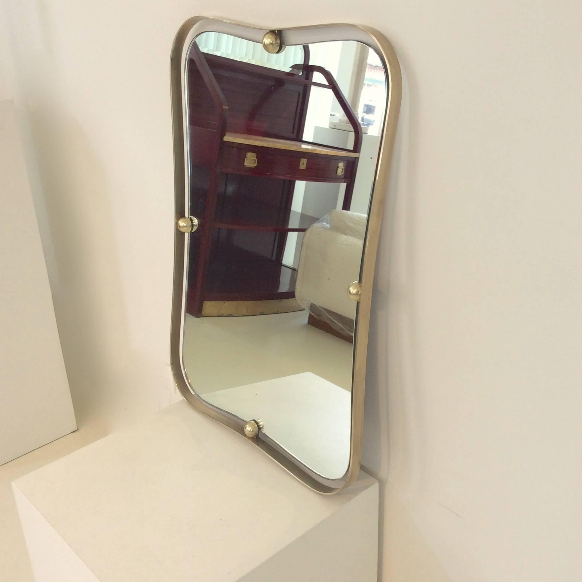 Elegant brass mirror, circa 1950 Italy, design attributed to Fontana Arte.
French designer Jean Royère has also made some object in the same style.

