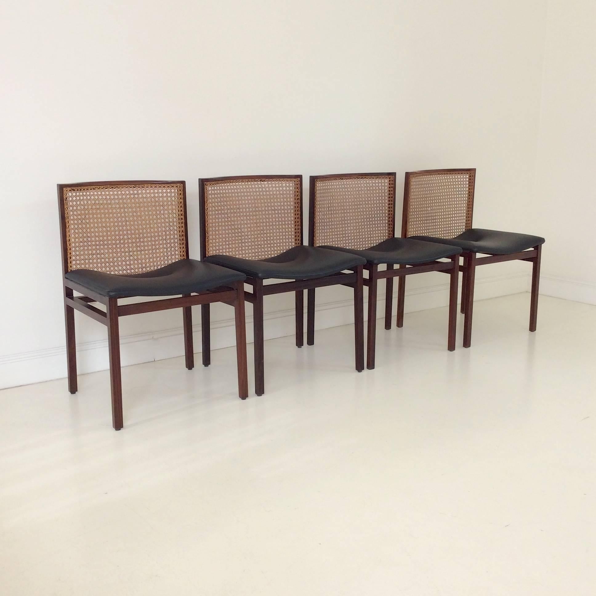 Set of four Scandinavian dining chairs, circa 1960, Denmark
Solid rosewood, black skai and cane.
Dimensions: 76 cm H, 44 cm seat H, 49 cm W, 50 cm D.
Good original condition.