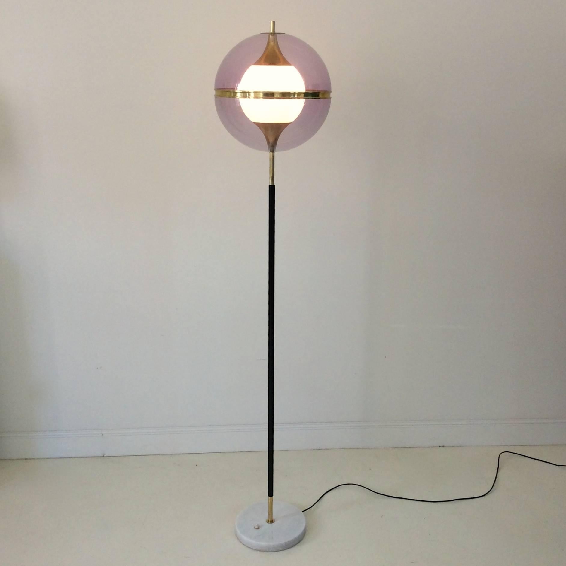 Floor lamp by Stilux, circa 1960, Italy.
Mauve Perspex and white frozed glass, black enameled metal, brass, gold aluminium and marble base.
One E27 bulb of 60 w.
Dimensions: 170 cm height, diameter of the sphere 35 cm, diameter of the base 25