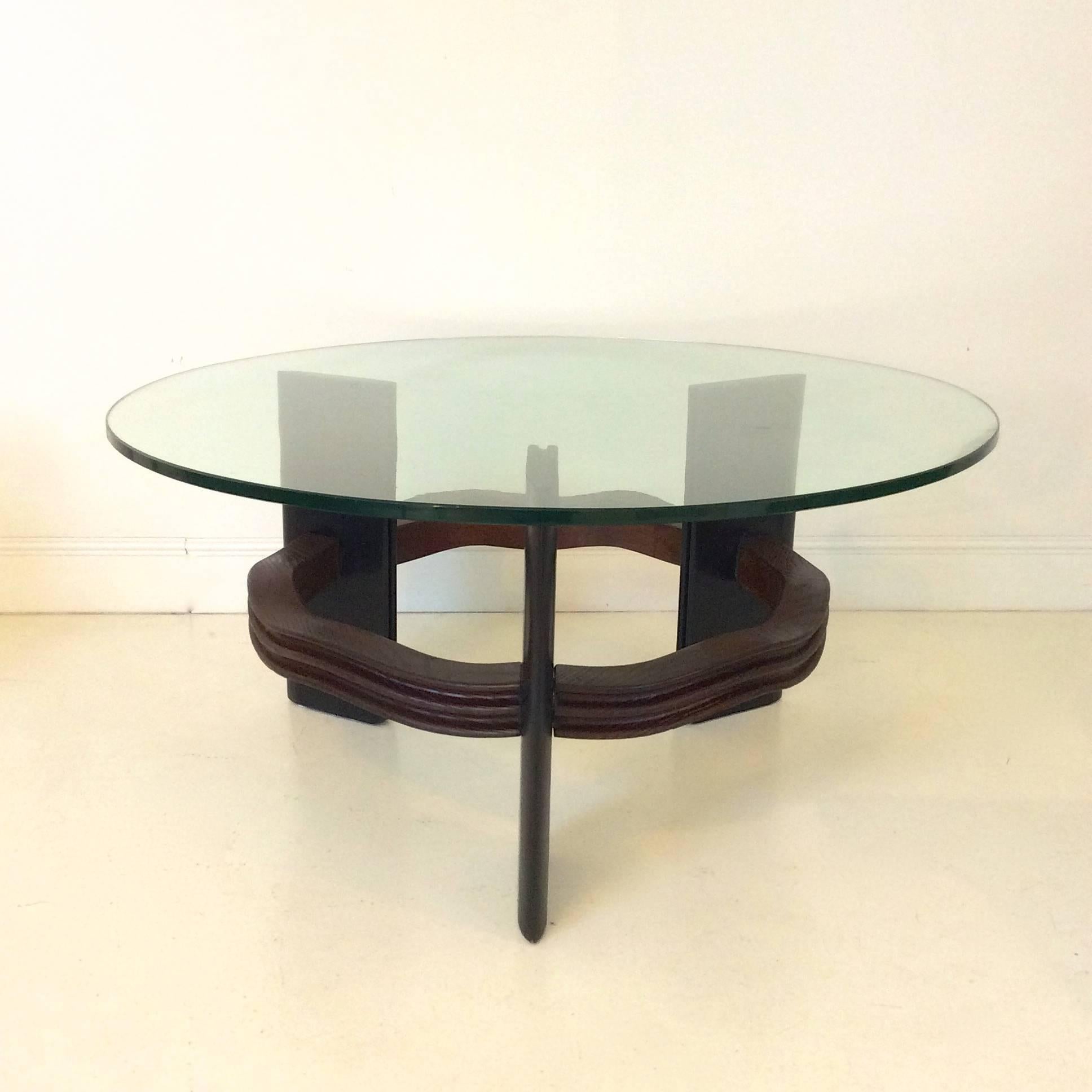 Rare Valabrega coffee table, circa 1940, Italy.
Three stained wood slat legs, dark carved wood stretcher, original glass top.
Good original condition.
Dimensions: 95 cm diameter, 45 cm H, thickness of the glass: 15 mm.
We ship worldwide.