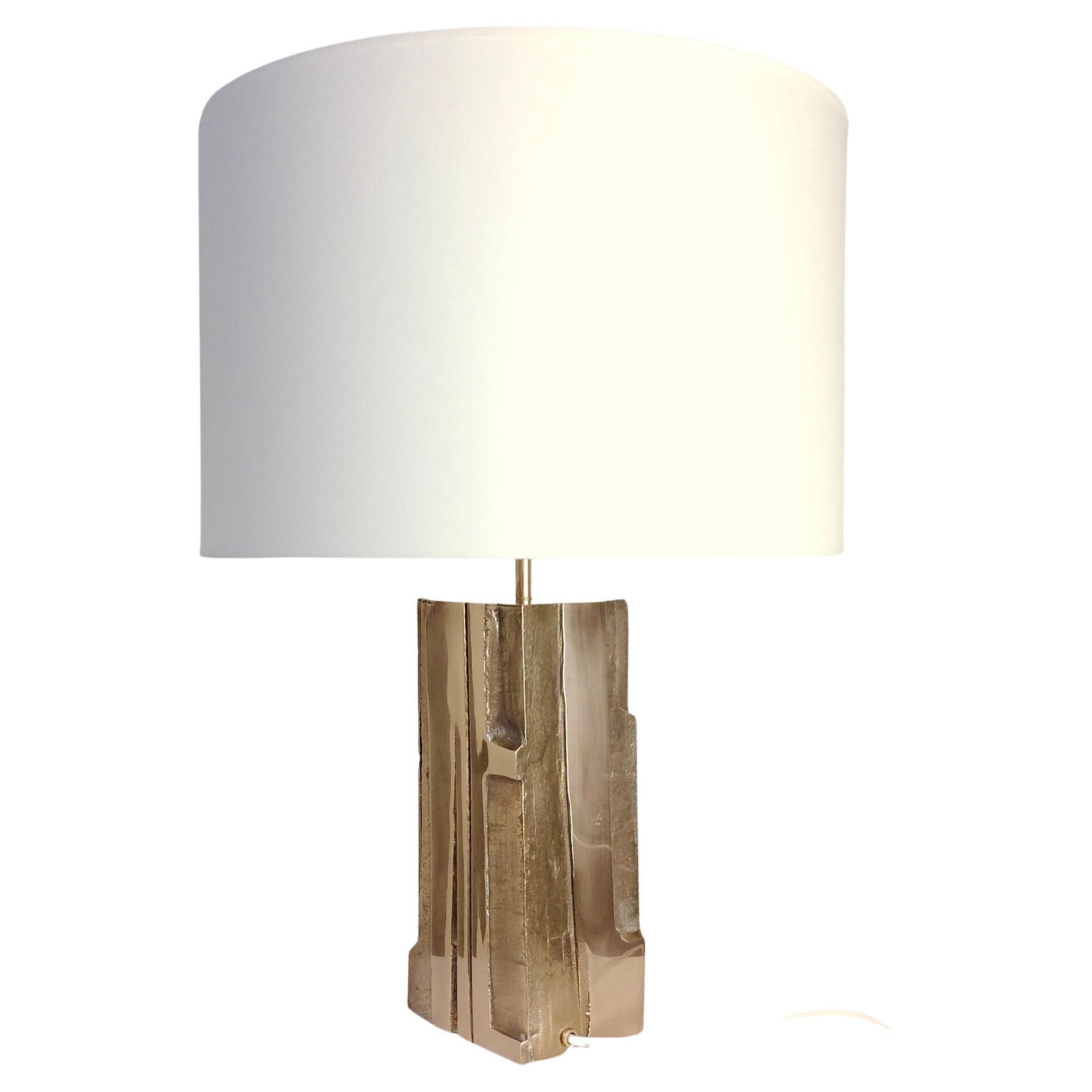 Nice Michel Mangematin abstract scupltural table lamp, circa 1970, France.
Polished bronze, new white fabric shade.
Signed M (slightly erased) on one side, see picture 11.
One E27 bulb of 60 W.
Rewired.
Dimensions: 59 cm height, 43 cm diameter. 
All