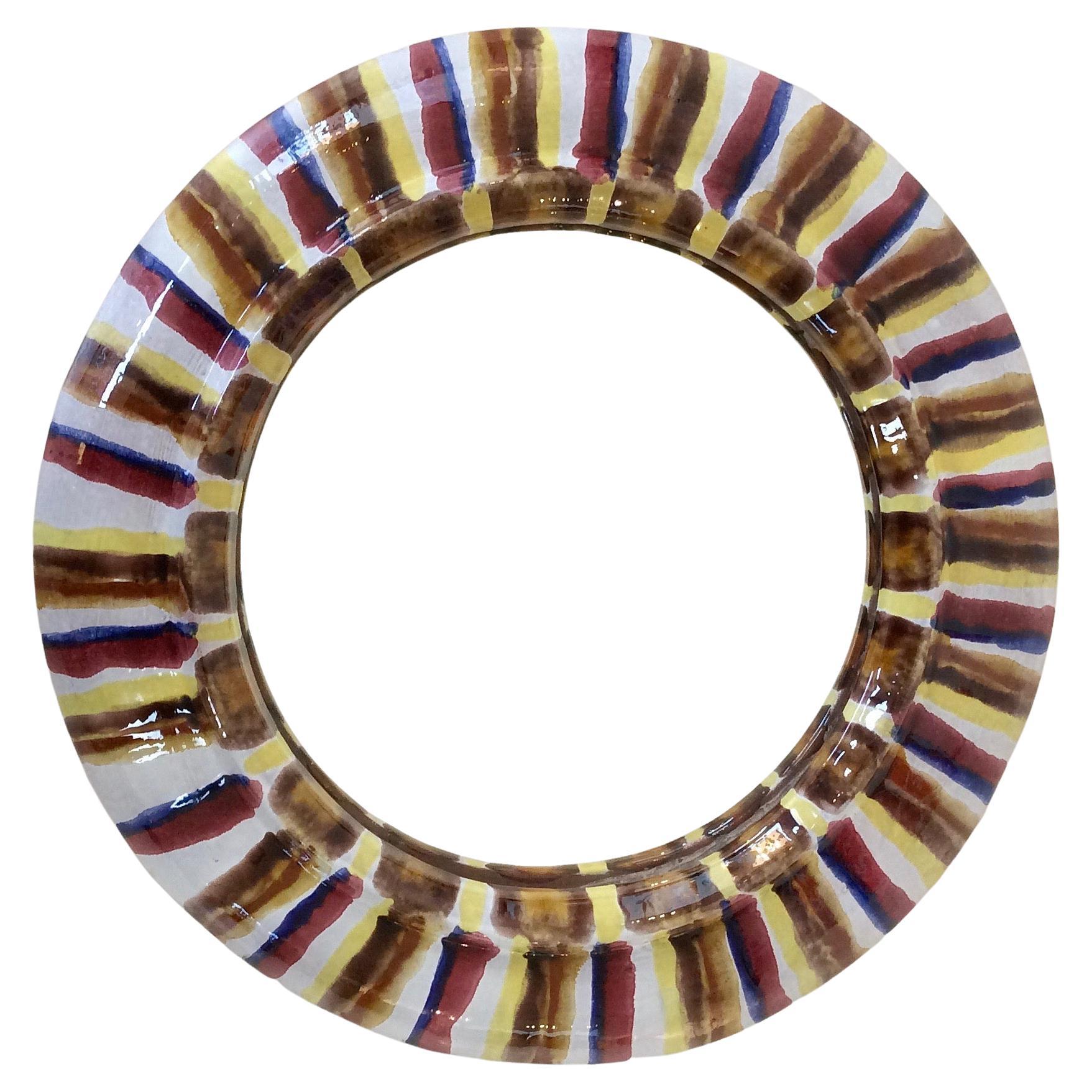 Round wall mirror, circa 1960, France.
White glazed ceramic, multicolor hand-painted stripes.
Dimensions: 28 cm diameter, 3 cm deep.
All purchases are covered by our Buyer Protection Guarantee.
This item can be returned within 7 days of delivery.
We