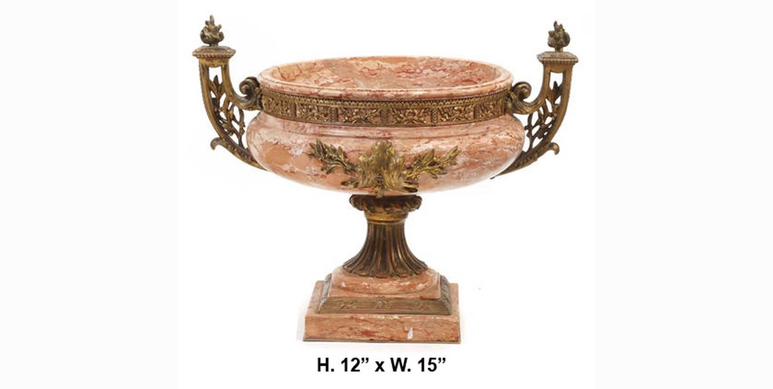 This beautiful, fine 19th century Italian neoclassical style gilt bronze mounted marble urn with intricate handles surmounted with a flame. The proportion is desirable and elegant.
The urn measurements is: Height 12 inches x Width: 15 inches x