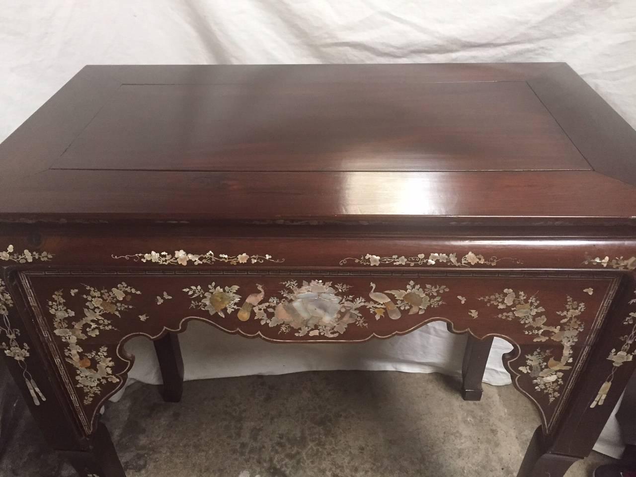 This unusual Chinese high altar table is finely inlaid with mother-of-pearl in birds and floral motif.
 