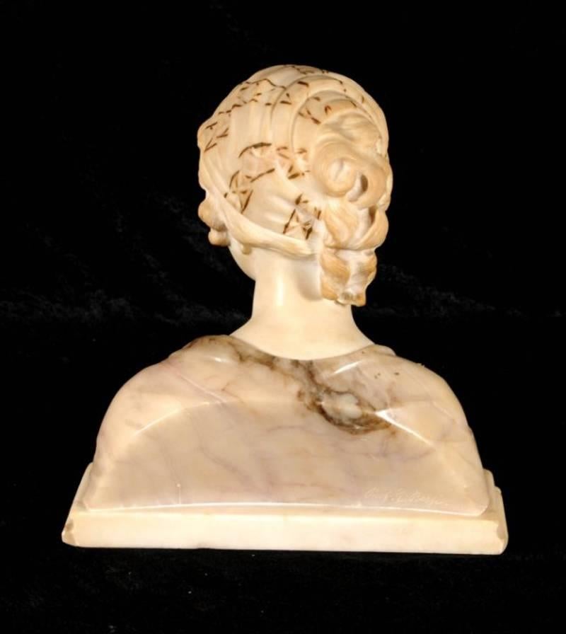 The well carved 19th century two-tone alabaster bust of a young girl on an alabaster base inscribed Mignon in the front and signed by Prof. G. Besfi.