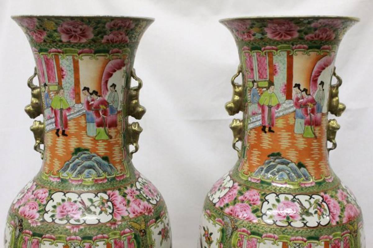 Pair of Chinese rose canton hand-painted porcelain vases on carved wood bases, circa 1900. 

This Chinese rose medallion has a unique pattern that helps make it recognizable. The numerous hand-painted medallions depict bird and flower scenes as