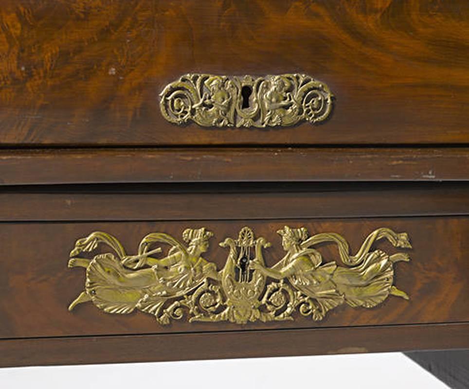 This impressive 19th century, French Empire style gilt bronze-mounted Fine mahogany roll-top desk, 
The blackstone top over three short gilt-bronze mounted drawers, issuing a barrel top desk over three pigeon holes, over three short drawers with