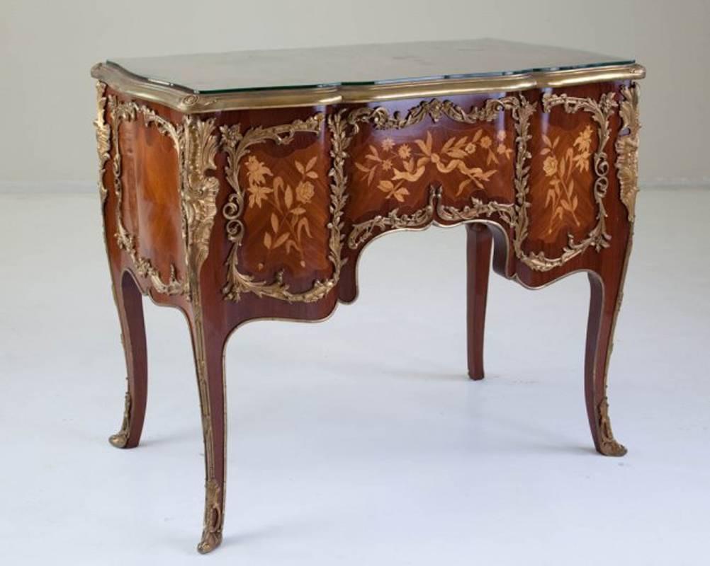 French mid-20th century ormolu-mounted marquetry inlaid five-drawer desk, the top, front and back are finely inlaid with flower and leaf motif with extensive ormolu mounting. Meticulous floral, scrolling leaf and Acanthus leaf motif gilt bronze-work