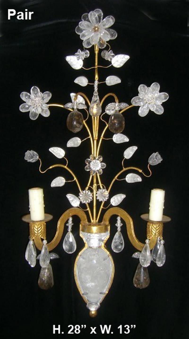 Pair of Bagues style hand-carved and hand polished rock crystal and Smokey quartz mounted on 23-karat gold leaf hand-forged wrought iron two-light sconces. (Z)