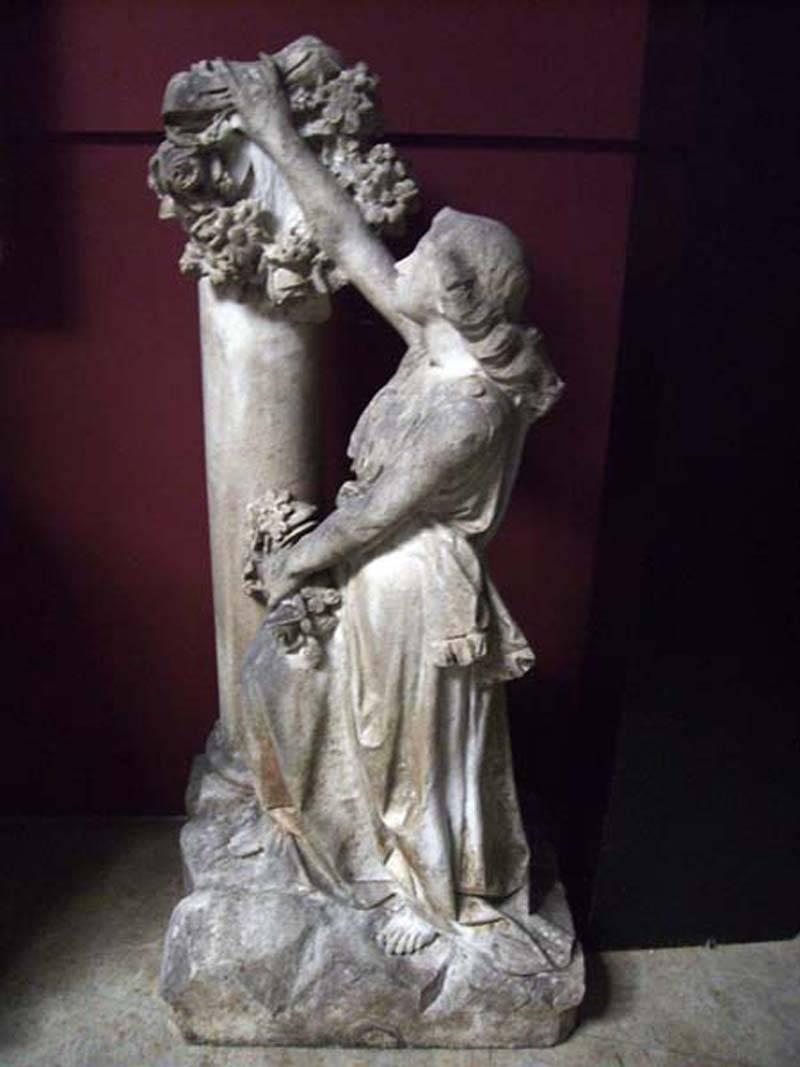 Impressive late 18th century Italian finely hand-carved Carrara marble posing woman leaning on pedestal holding a wreath.
 